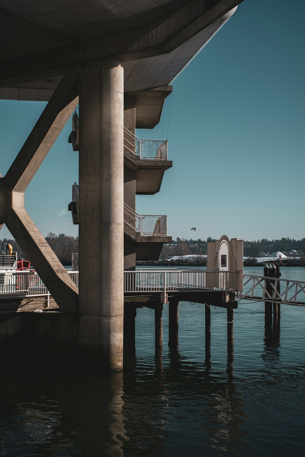 a bridge over a body of water next to a pier