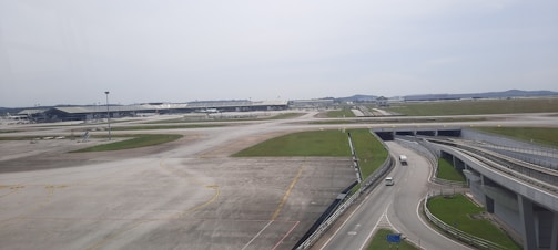 Wide shot of the Maranhão airport runway with Aeroisa vehicles in action.