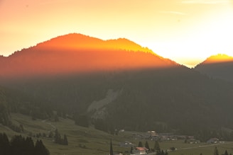 A warm, glowing sunset over a biblical village scene, evoking peace and gratitude.