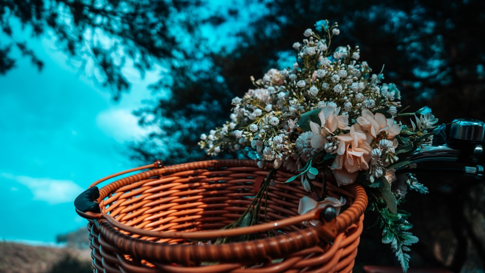 a wicker basket with flowers in it