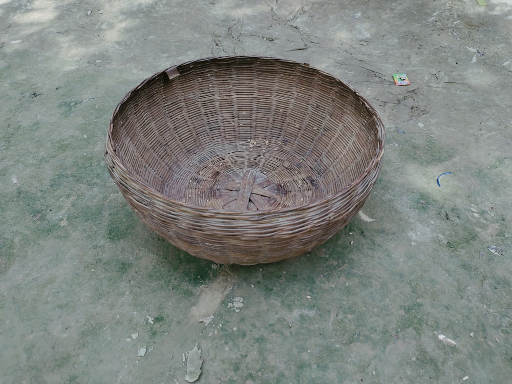 a wicker basket sitting on the ground