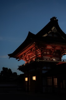 A close-up of traditional Japanese architectural details illuminated by warm lighting.