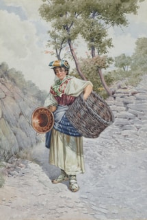 A person wearing traditional clothing stands on a rocky path. They hold a large empty basket and a smaller rounded container. The path is surrounded by trees with green foliage, creating a serene and rustic outdoor setting.