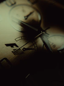 A sophisticated watch face illuminated softly against a dark background, emphasizing its intricate details.