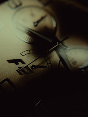 Close-up of a finely detailed artisan watch resting on a wooden surface with soft natural light.