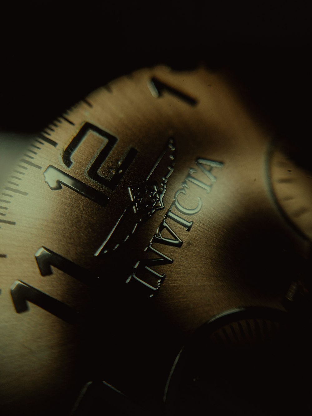 a close up of a watch face with a black background