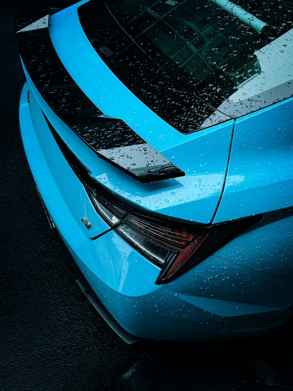 a close up of the hood of a blue car