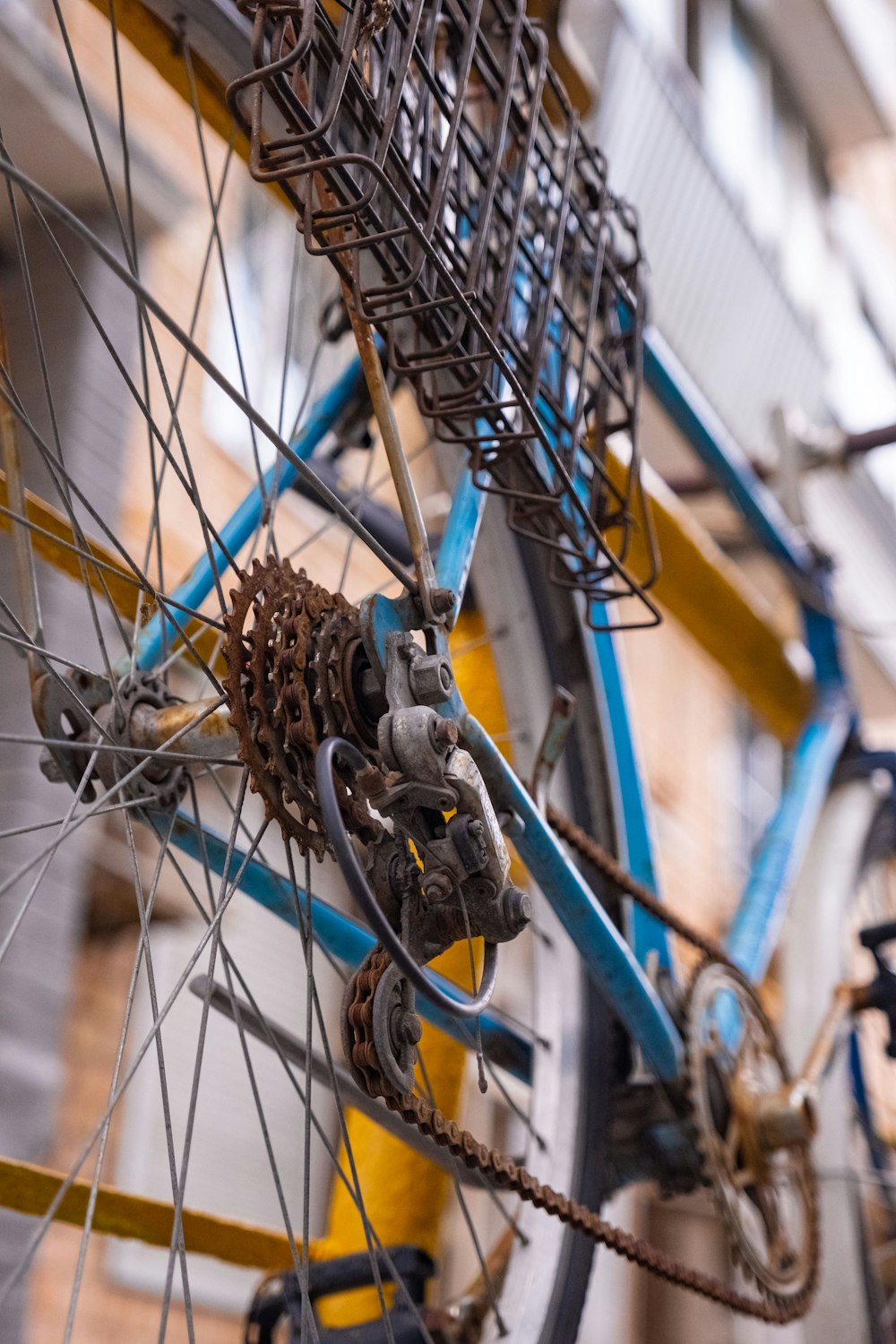 a close up of a bicycle wheel with a building in the background