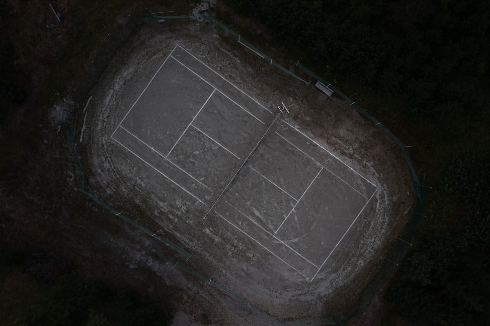 an aerial view of a tennis court at night