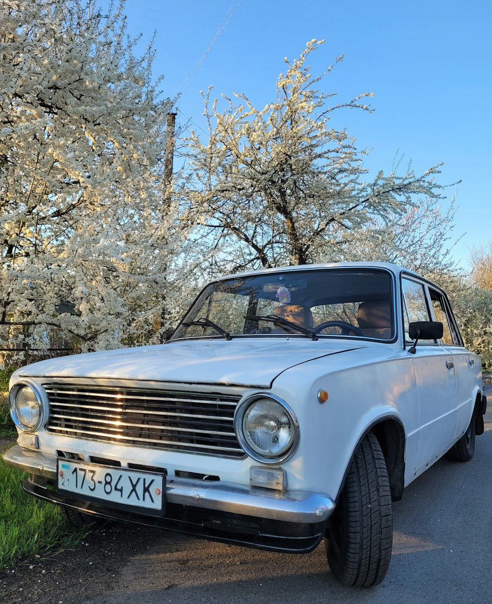 a white car parked on the side of the road