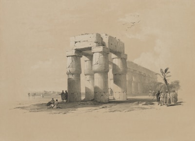 An illustration depicting ancient ruins with large stone pillars arranged in a rectangular structure. The architectural style suggests it is a historical temple or monument from an ancient civilization. Several figures are present, some sitting and others walking, dressed in clothing typical of an earlier period, indicating a cultural or archaeological theme. Birds are seen flying above in the sky and a few trees are scattered around, contributing to a serene landscape.