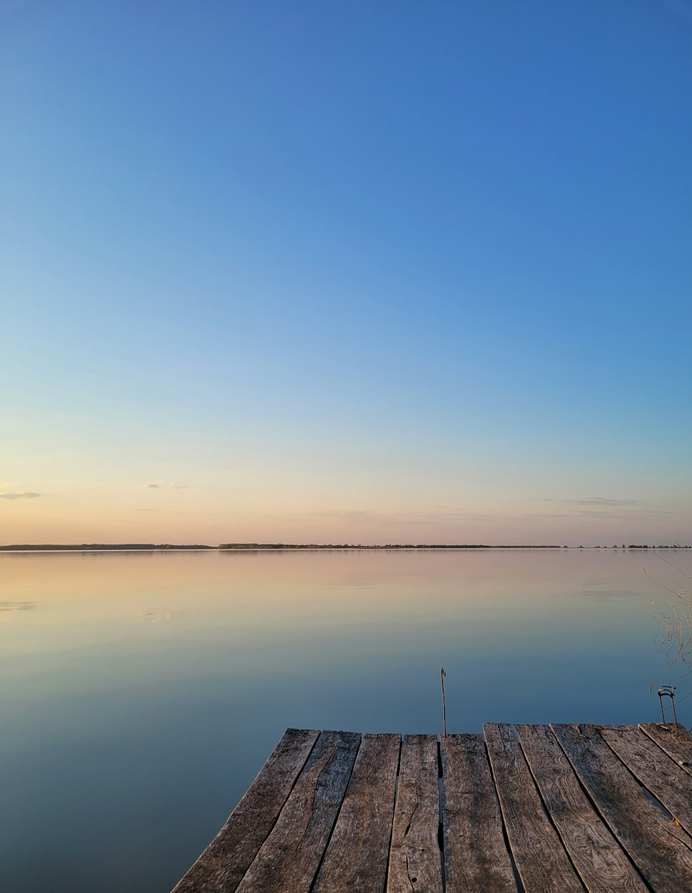 a wooden dock sitting on top of a lake