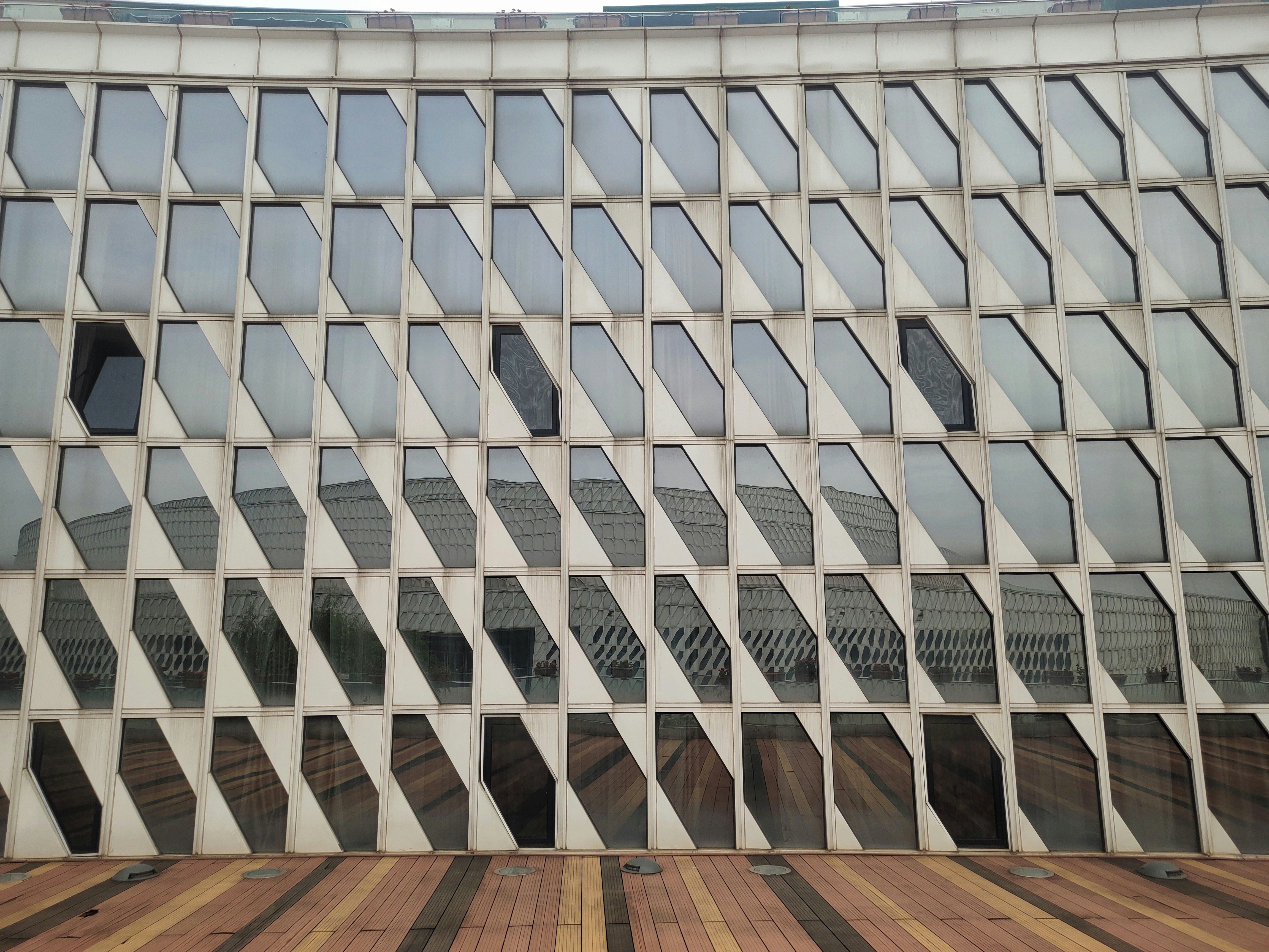 a large building with many windows reflecting the sky