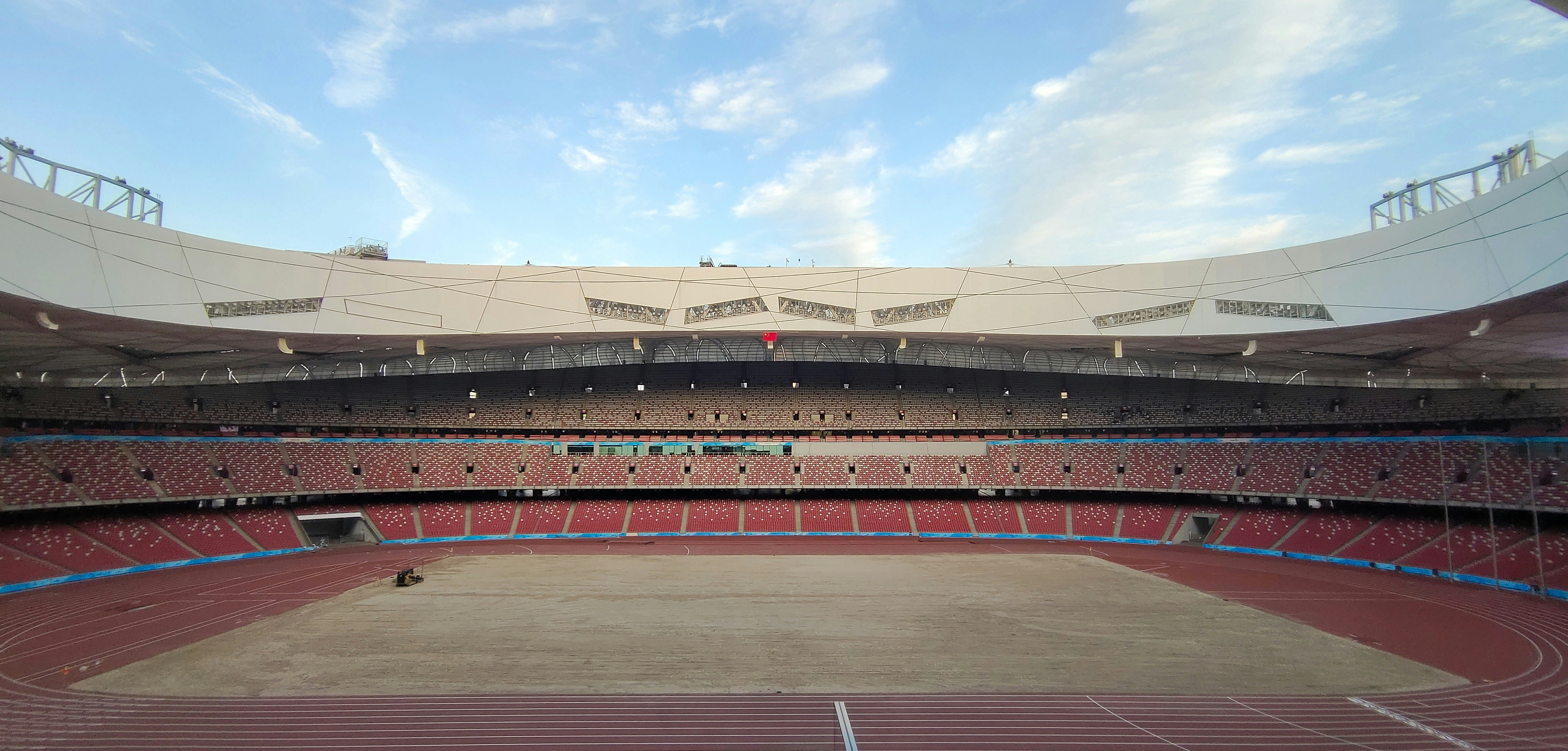 a large empty stadium with a sky background