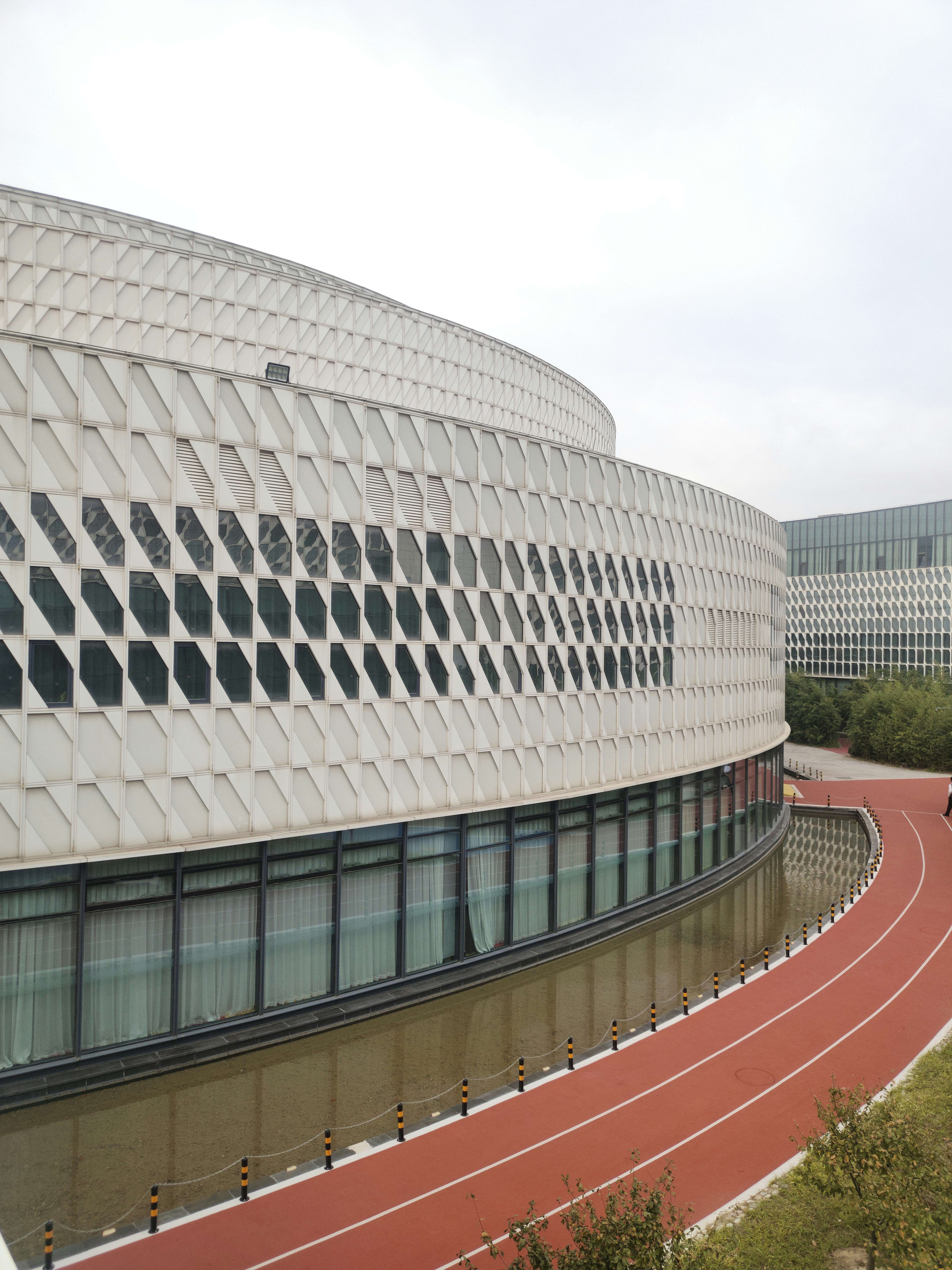 a large building with a curved road in front of it