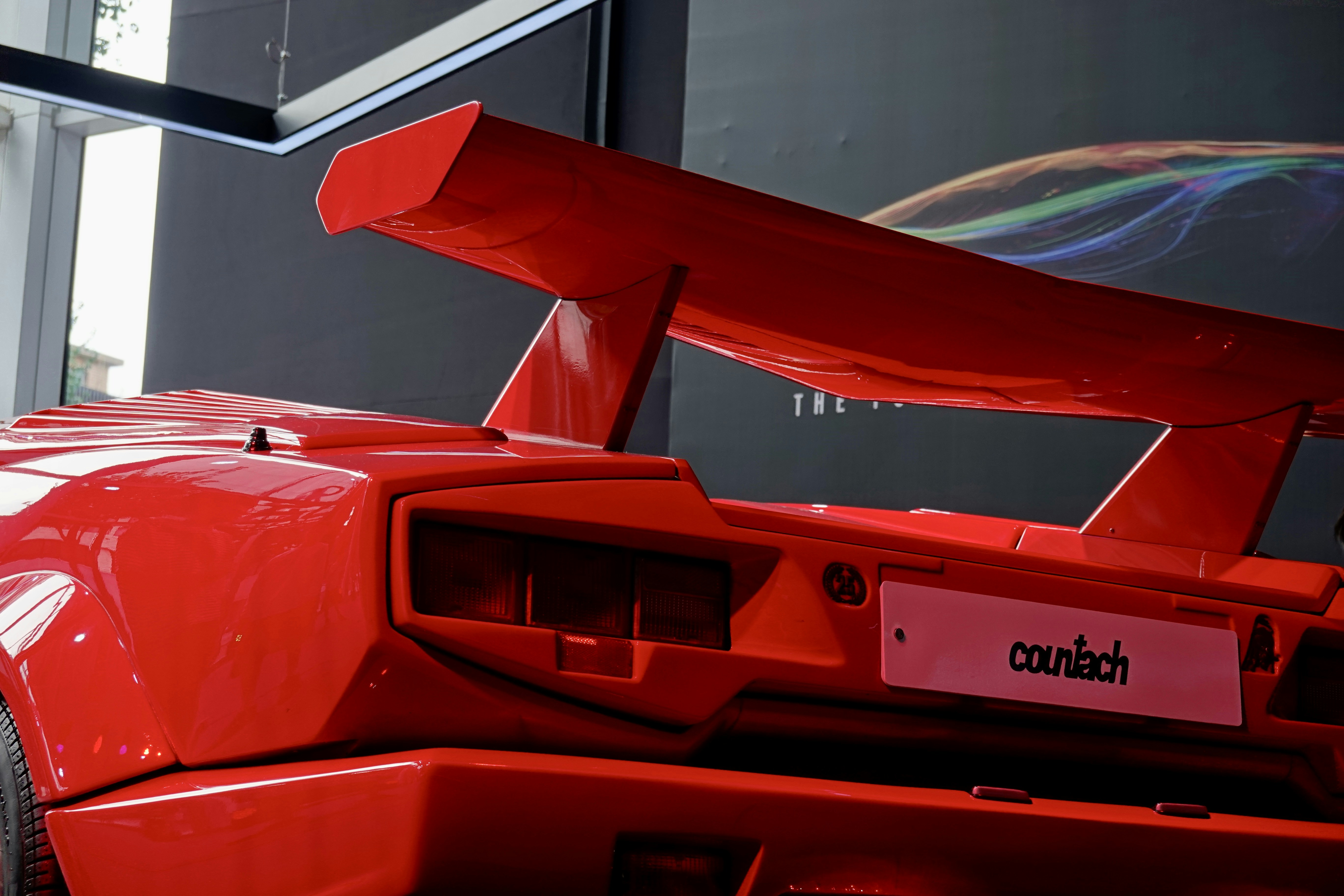 a red sports car parked in front of a building