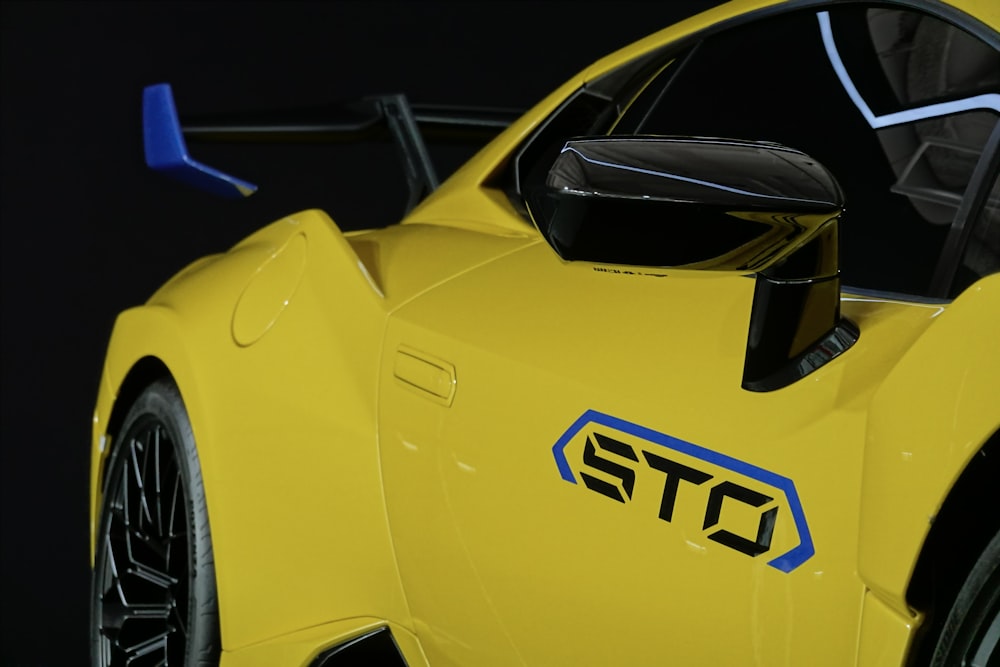 a close up of a yellow sports car