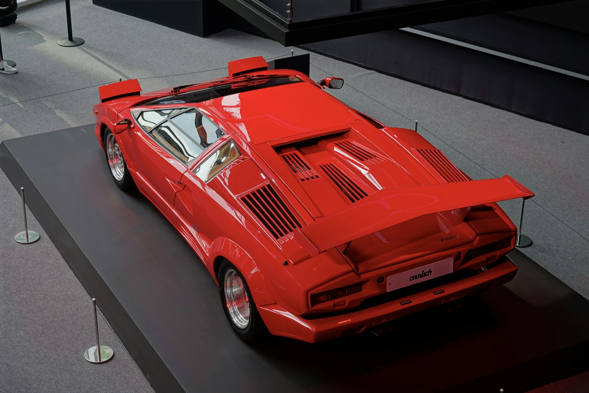 a red sports car on display in a museum