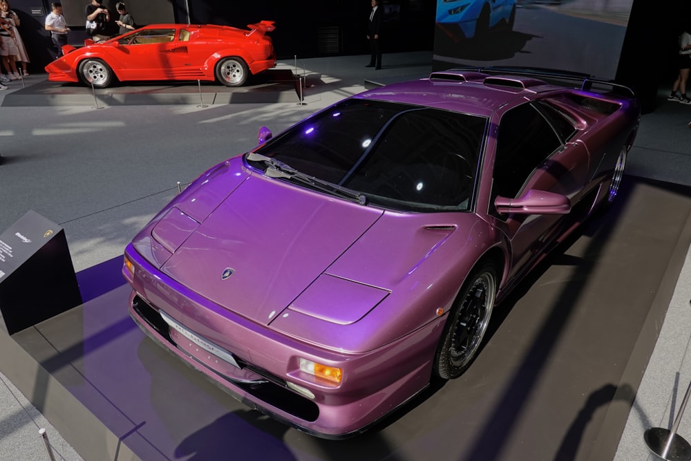 a purple sports car on display at a car show