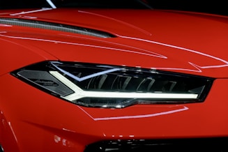 a close up of the front of a red sports car