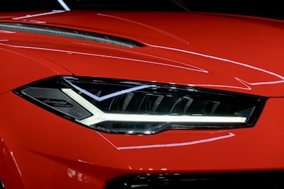 a close up of the front of a red sports car