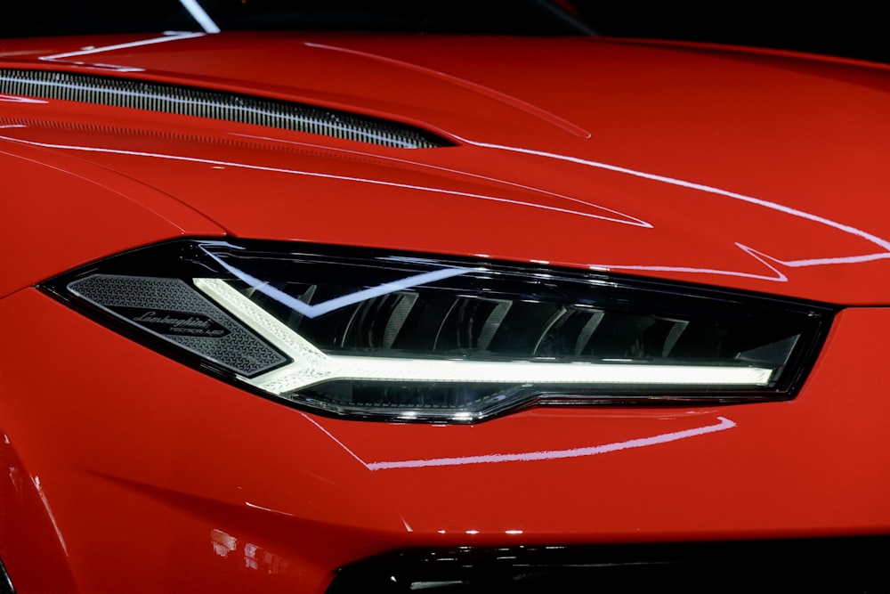 a close up of the front of a red sports car