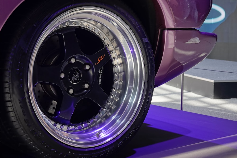 a close up of a wheel on a purple car