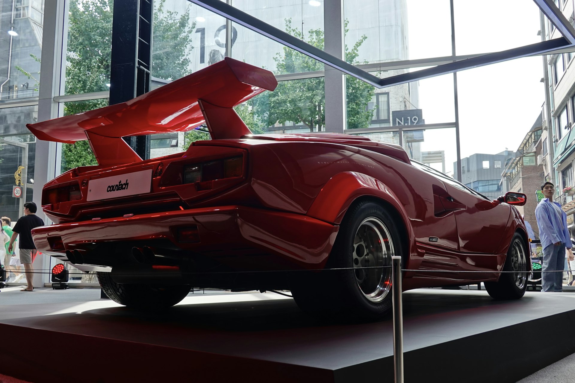 a red sports car on display in a building