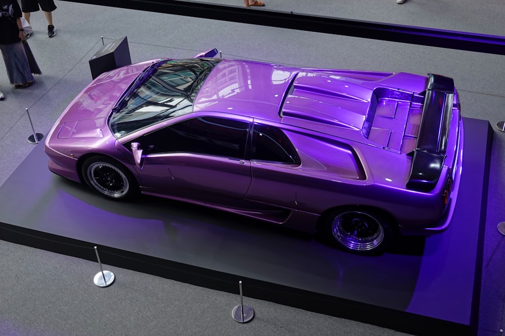 a purple car on display at a car show
