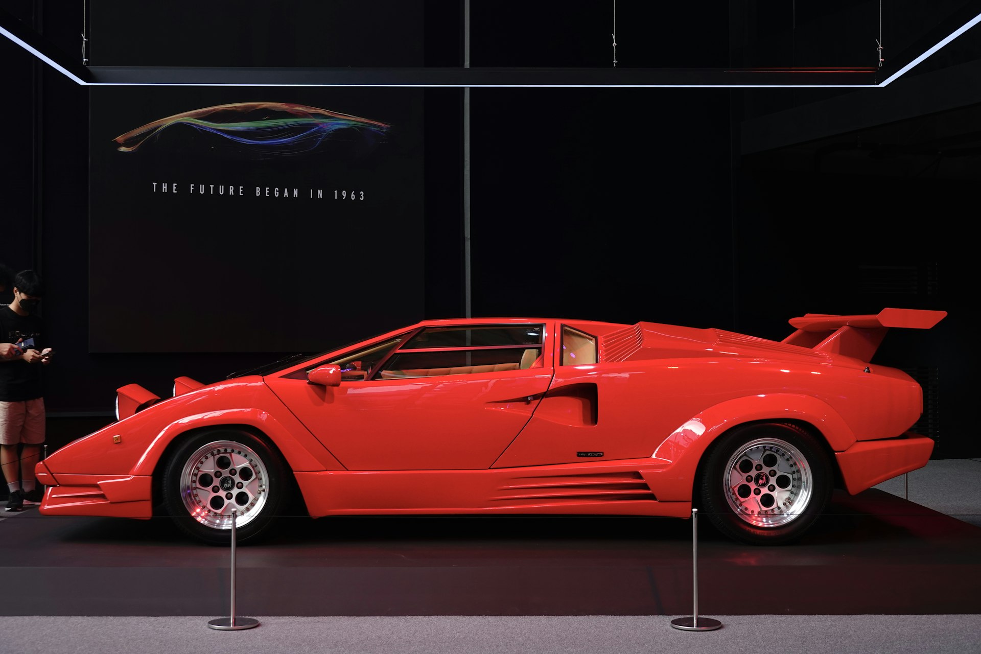 a red sports car on display at a museum