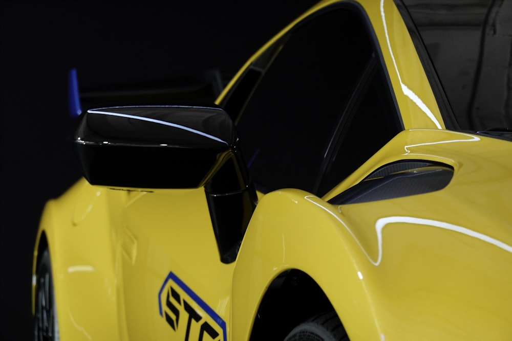 a close up of a yellow sports car