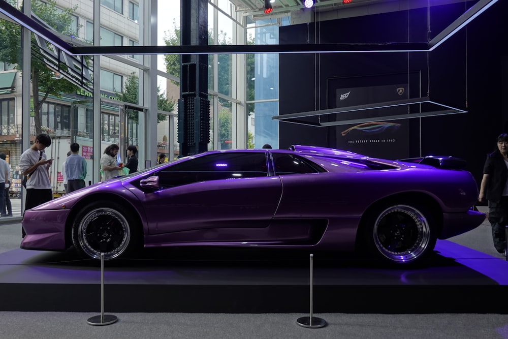 a purple sports car on display in a building