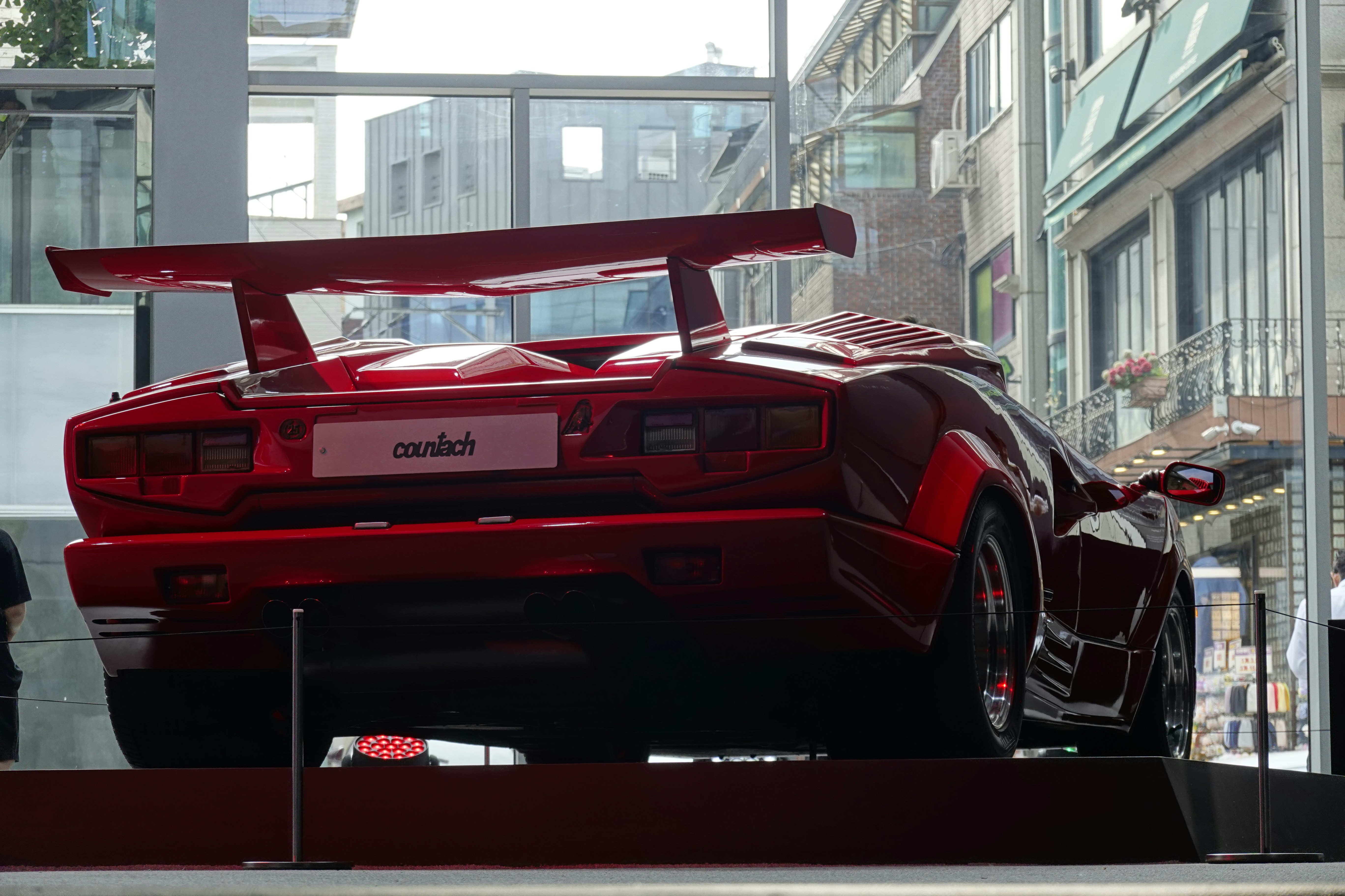 a red sports car parked in front of a building