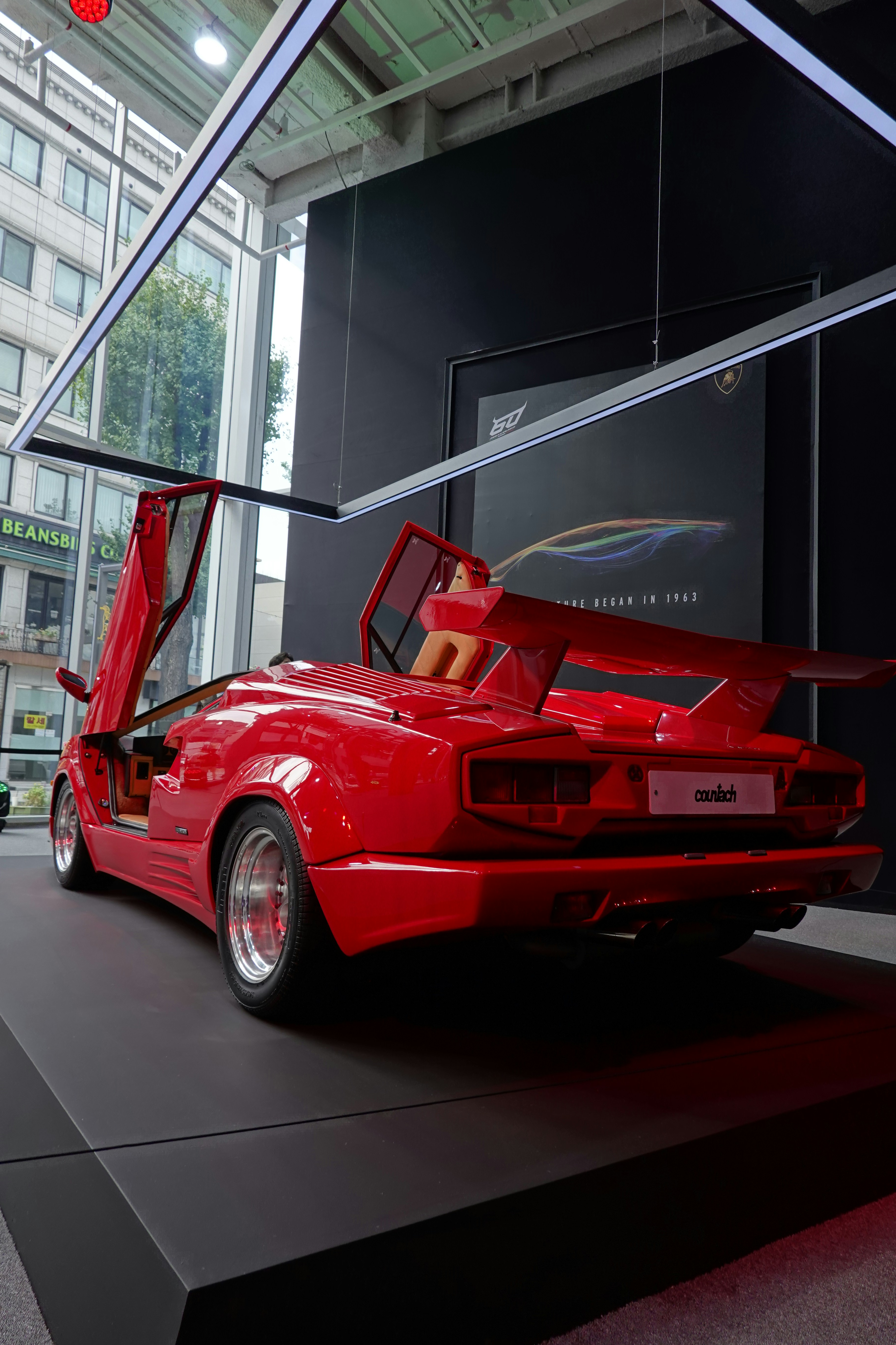 a red sports car on display in a building
