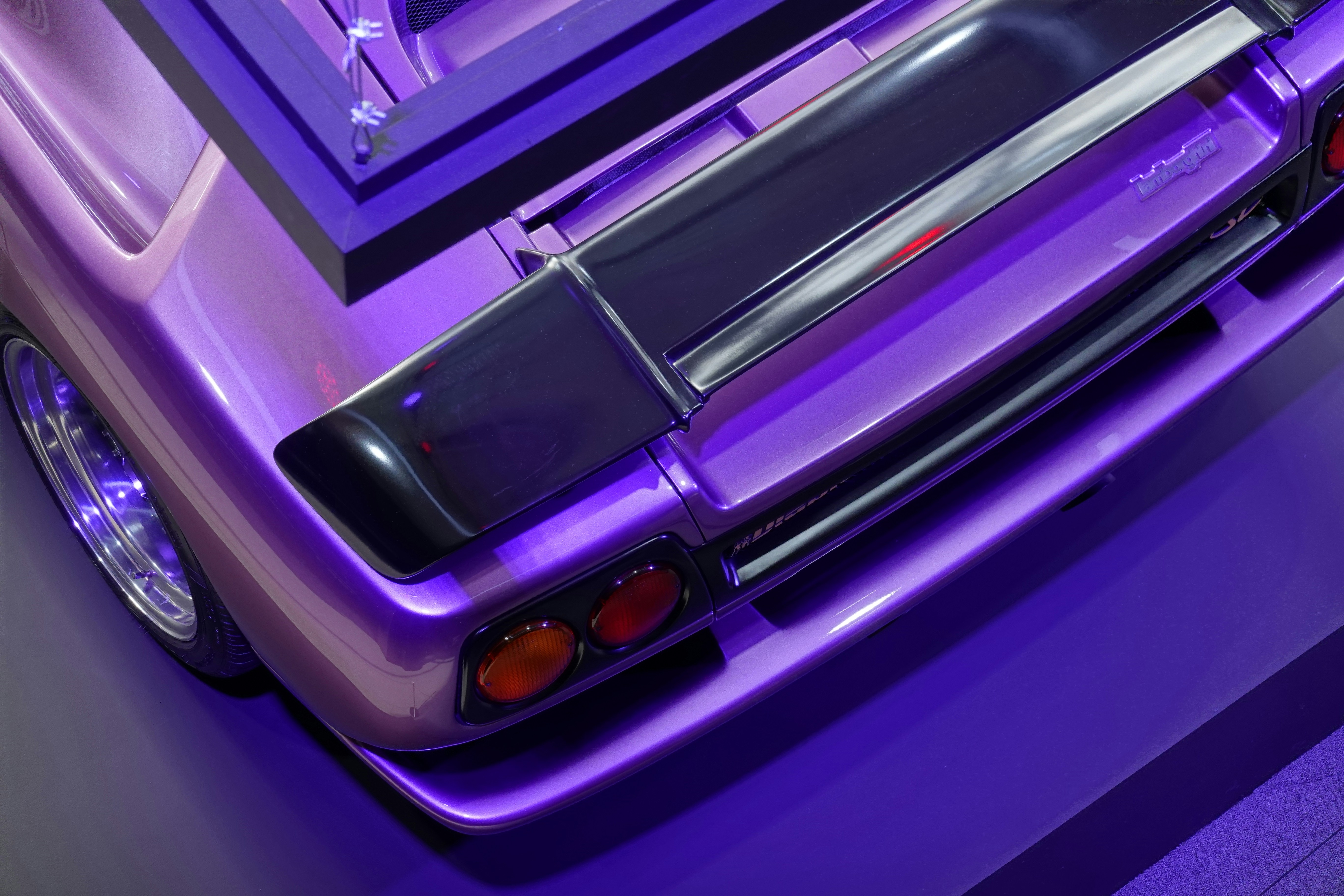 a purple car parked in front of a mirror