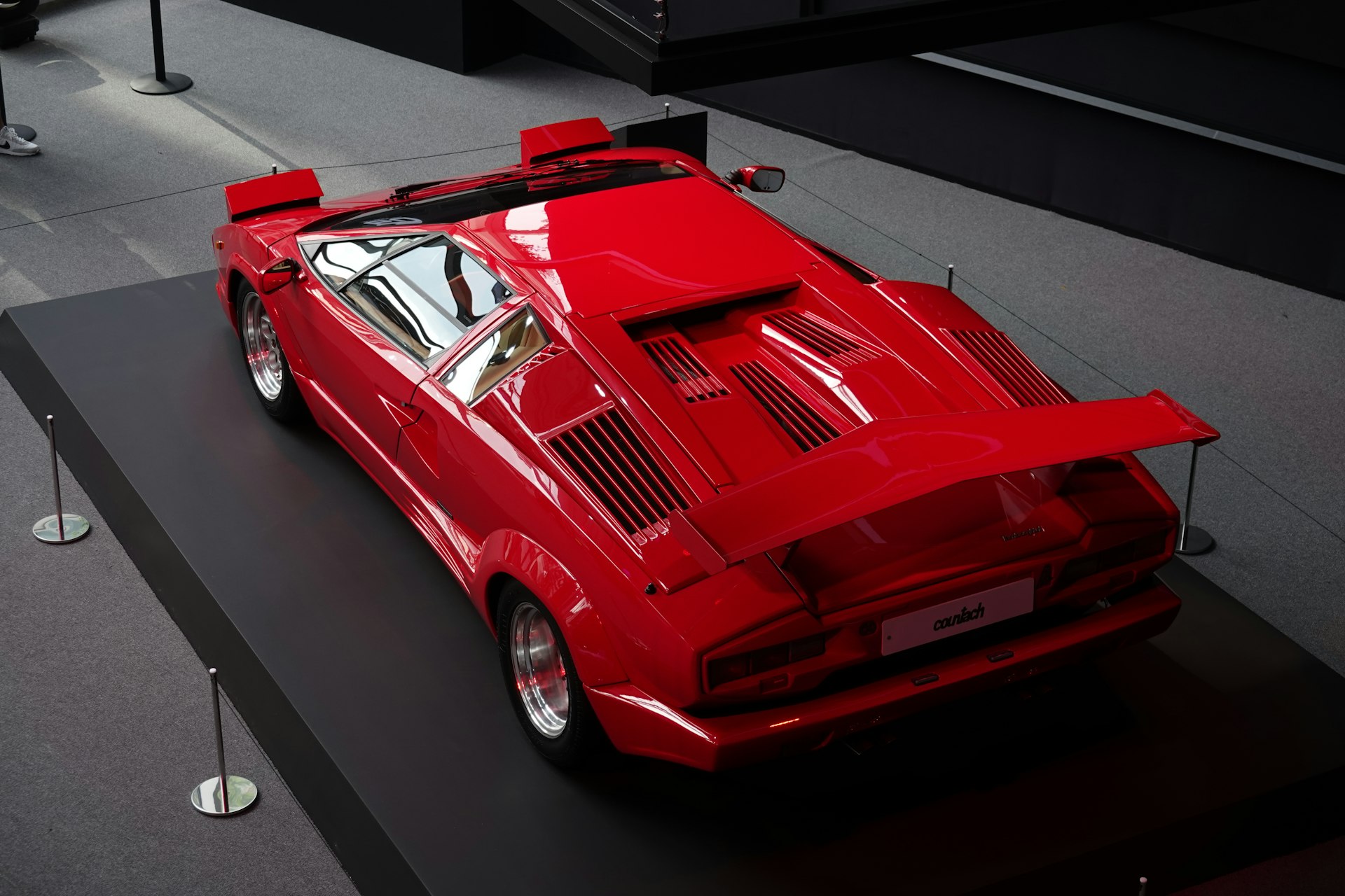 a red sports car on display in a museum