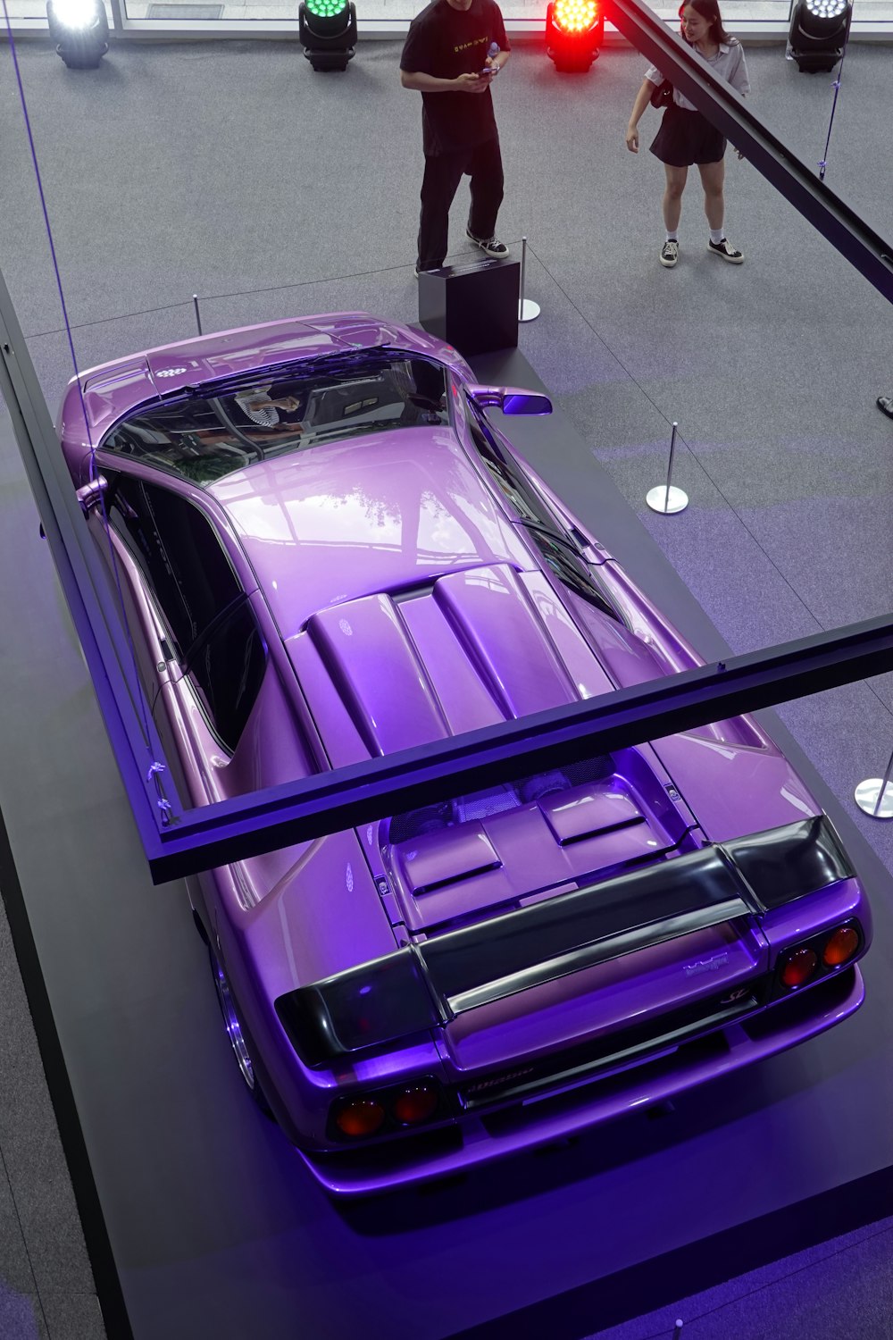 a purple car is on display in a museum