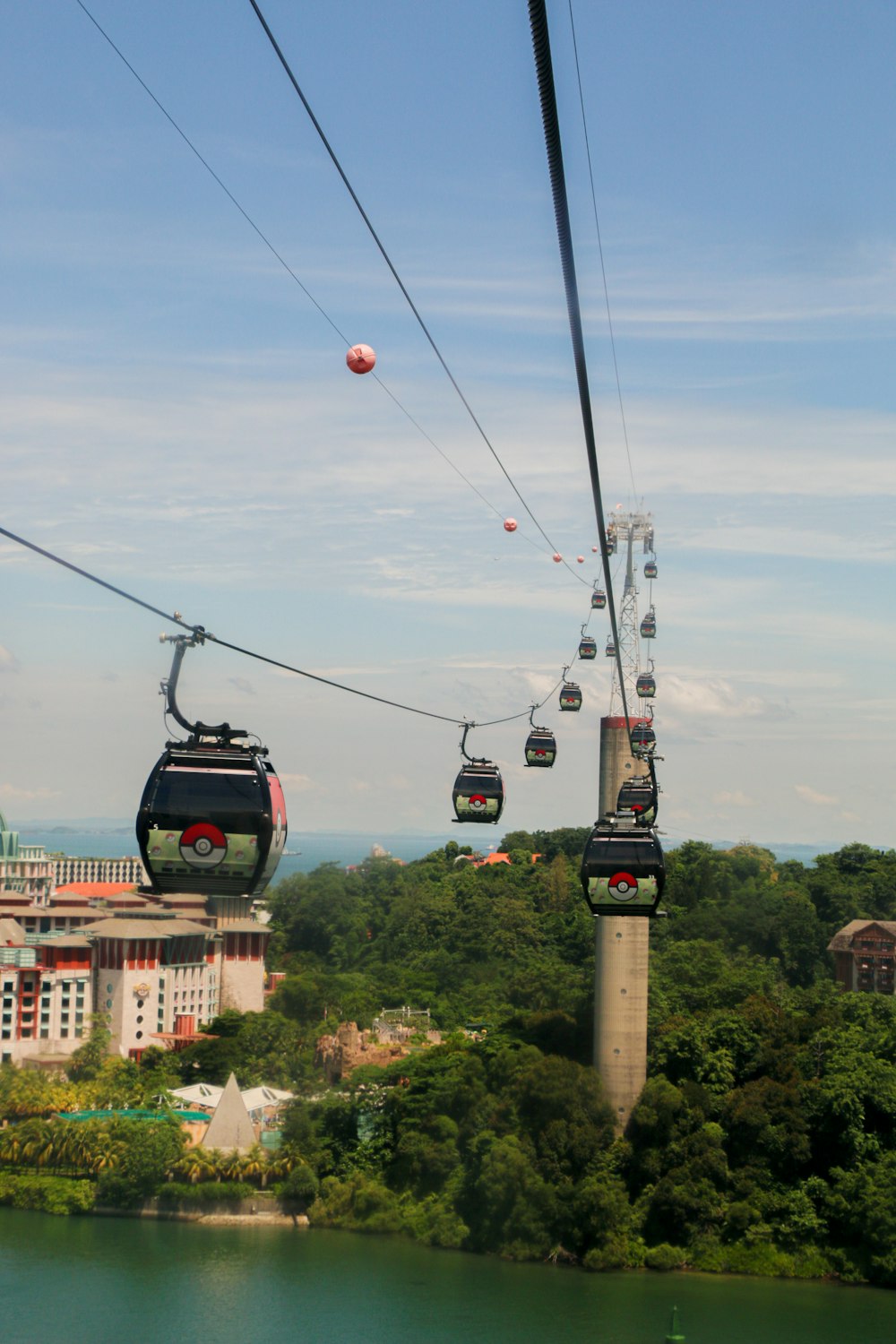 a group of people riding a ski lift over a lake