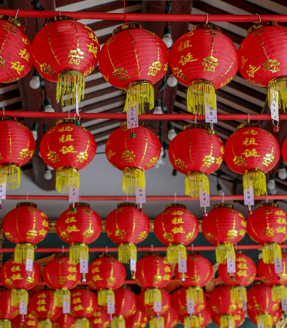 a bunch of red lanterns hanging from a ceiling