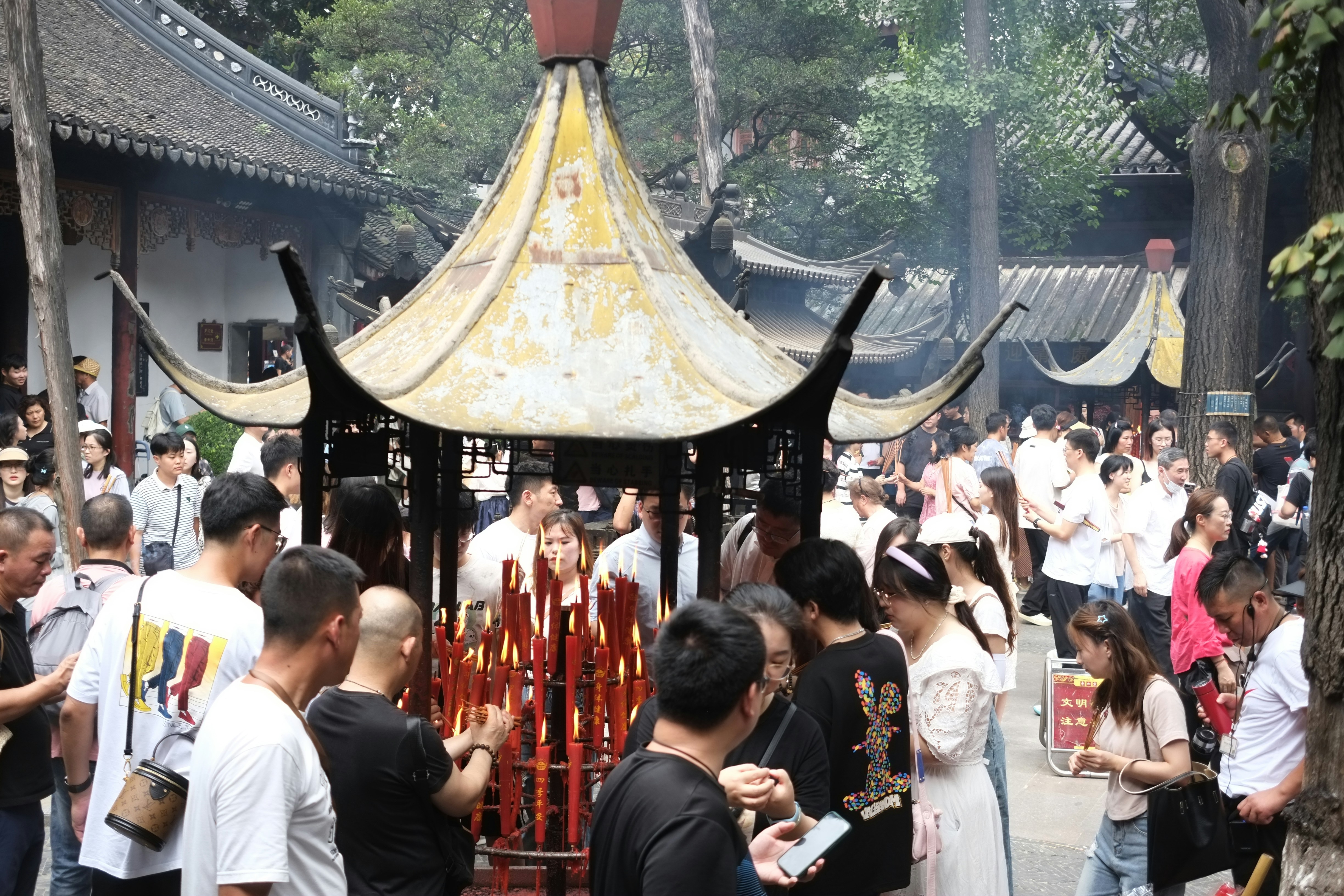 a group of people standing around a pagoda
