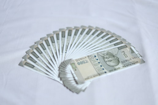 Several 500 Indian rupee banknotes arranged in a fanned pattern on a white background.