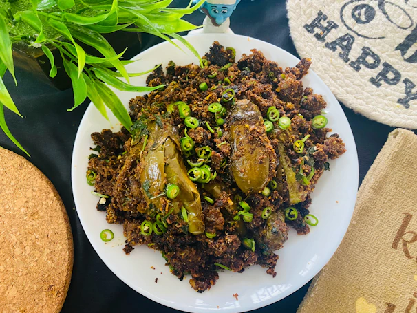 Vibrant sambal eggplant delight served steaming hot with fresh herbs garnish.