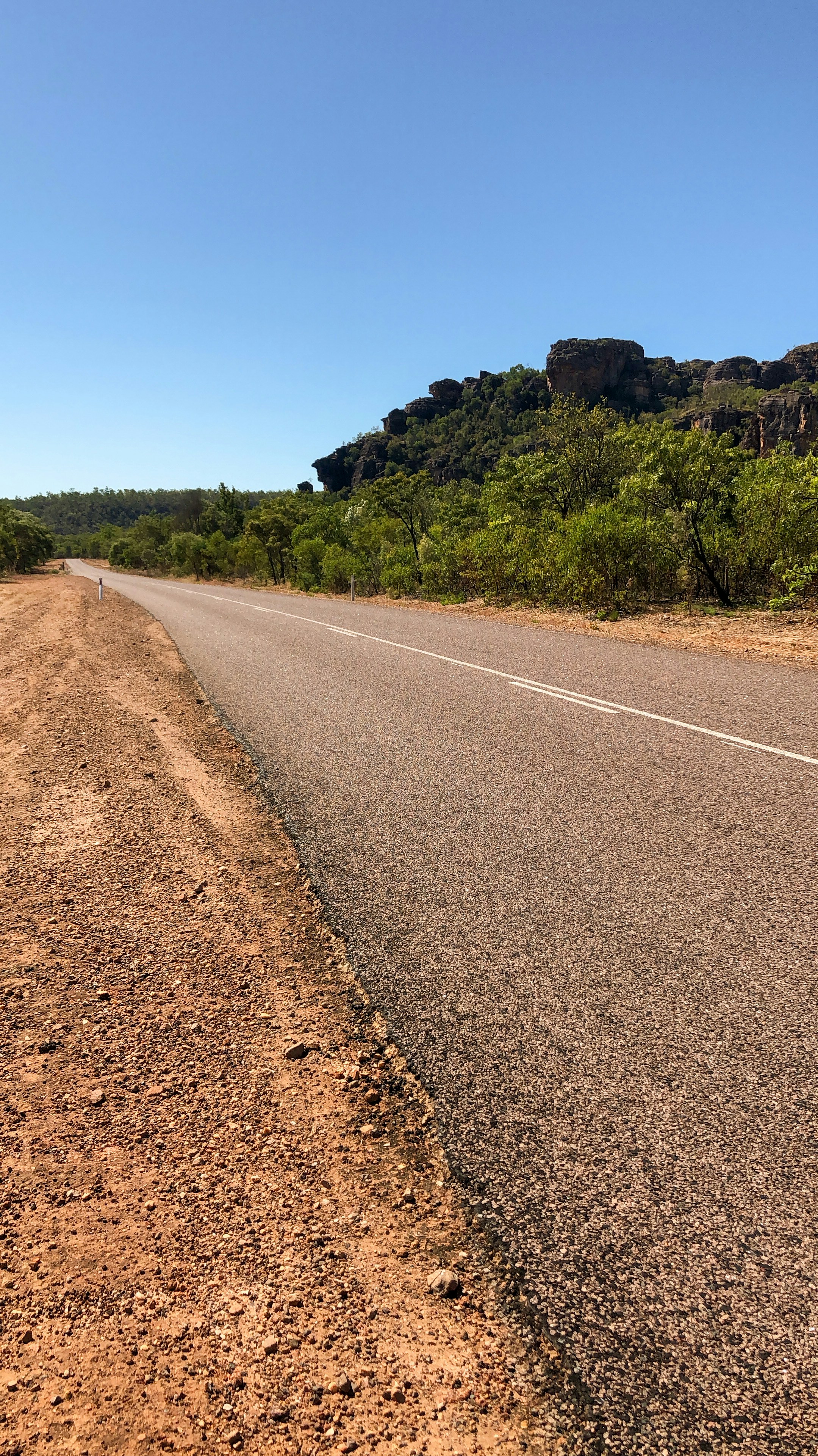 an empty road in the middle of the desert