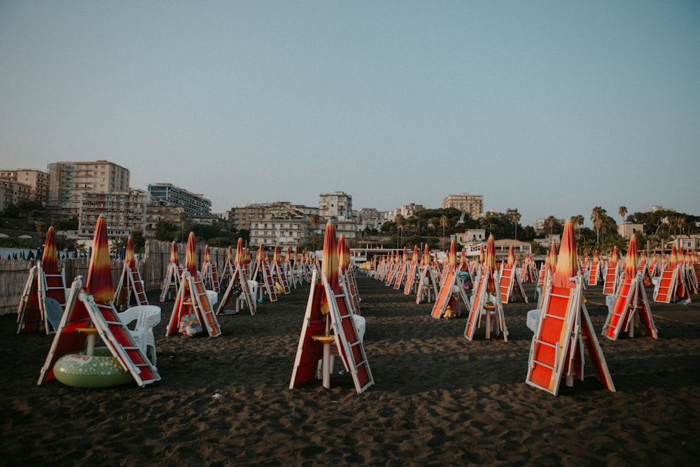 a bunch of red and white signs on a beach