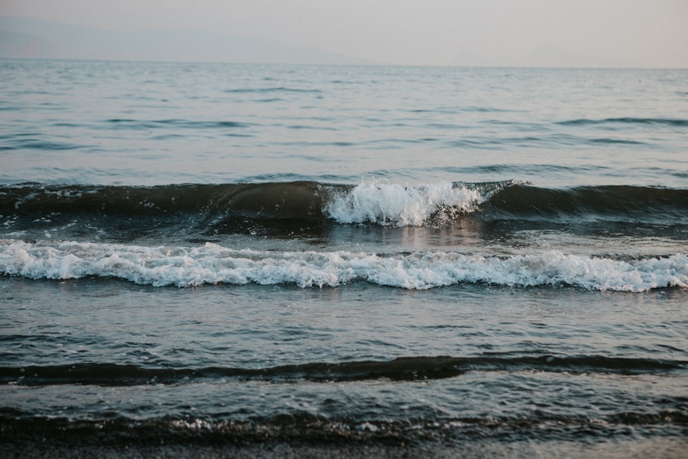 a large body of water with waves coming in to shore