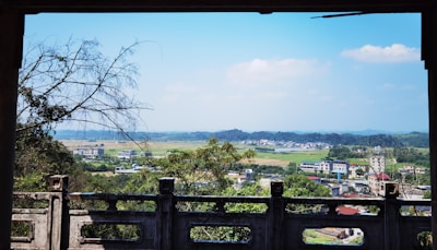 A scenic view of a rural landscape with fields and traditional houses.