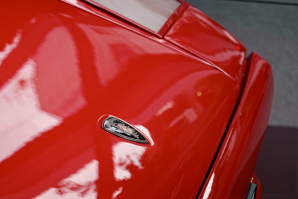 a close up of the emblem on a red car