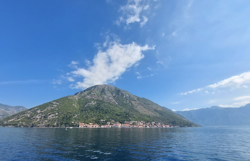 a large body of water with a mountain in the background