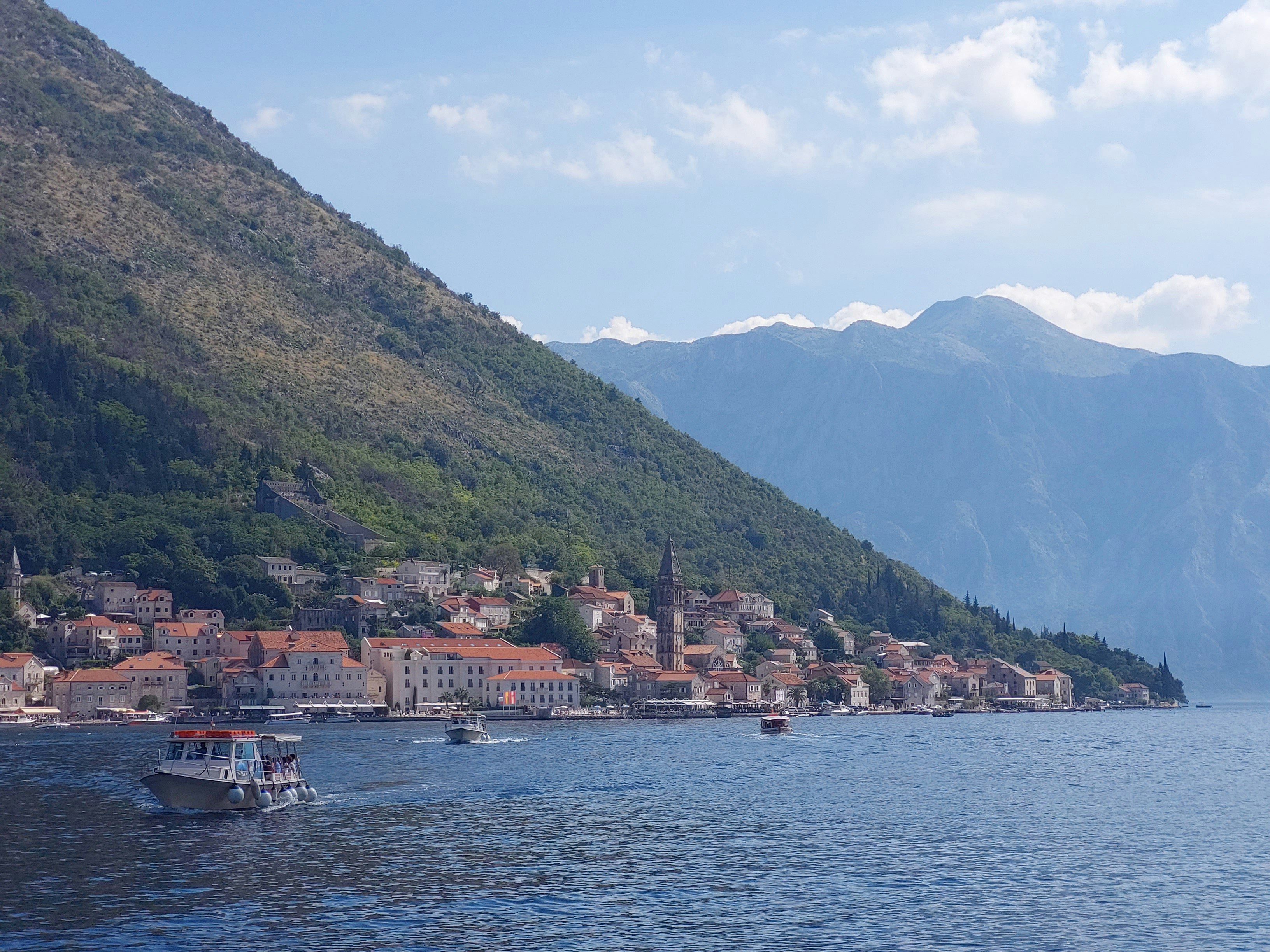 a large body of water surrounded by mountains, 