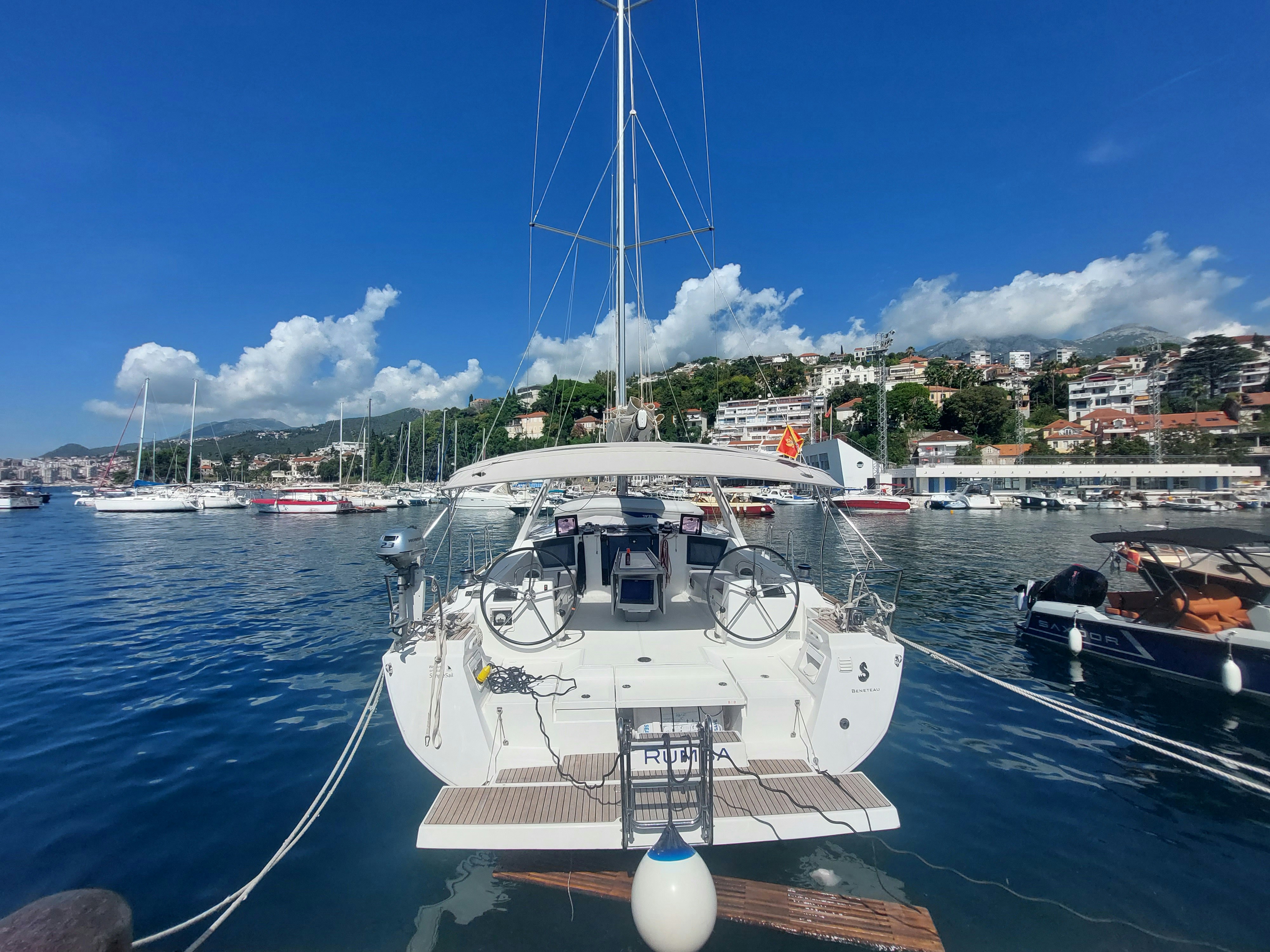a sailboat docked in a harbor with other boats
